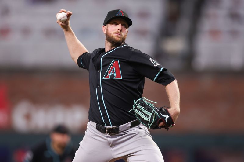 Jun 4, 2025; Atlanta, Georgia, USA; Arizona Diamondbacks starting pitcher Merrill Kelly (29) throws against the Atlanta Braves in the sixth inning at Truist Park. Mandatory Credit: Brett Davis-Imagn Images
