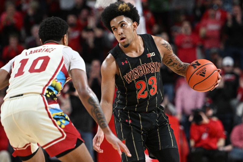 Feb 11, 2023; Lincoln, Nebraska, USA;  Wisconsin Badgers guard Chucky Hepburn (23) dribbles against Nebraska Cornhuskers guard Jamarques Lawrence (10) in the second half at Pinnacle Bank Arena. Mandatory Credit: Steven Branscombe-USA TODAY Sports