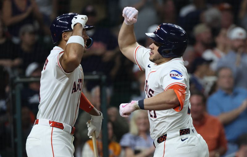 May 29, 2025; Houston, Texas, USA;  Houston Astros right fielder Cam Smith (11) celebrates catcher Yainer Diaz (21) home run against the Tampa Bay Rays in the fifth inning at Daikin Park. Mandatory Credit: Thomas Shea-Imagn Images