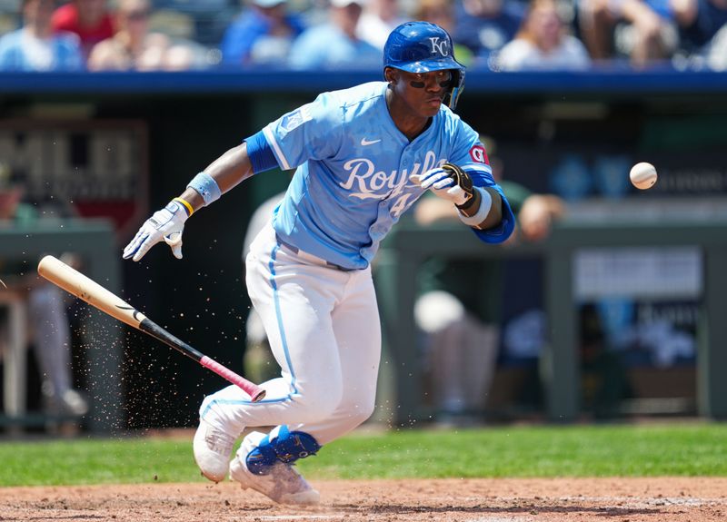 May 19, 2024; Kansas City, Missouri, USA; Kansas City Royals left fielder Dairon Blanco (44) hits a bunt single during the sixth inning against the Oakland Athletics at Kauffman Stadium. Mandatory Credit: Jay Biggerstaff-USA TODAY Sports