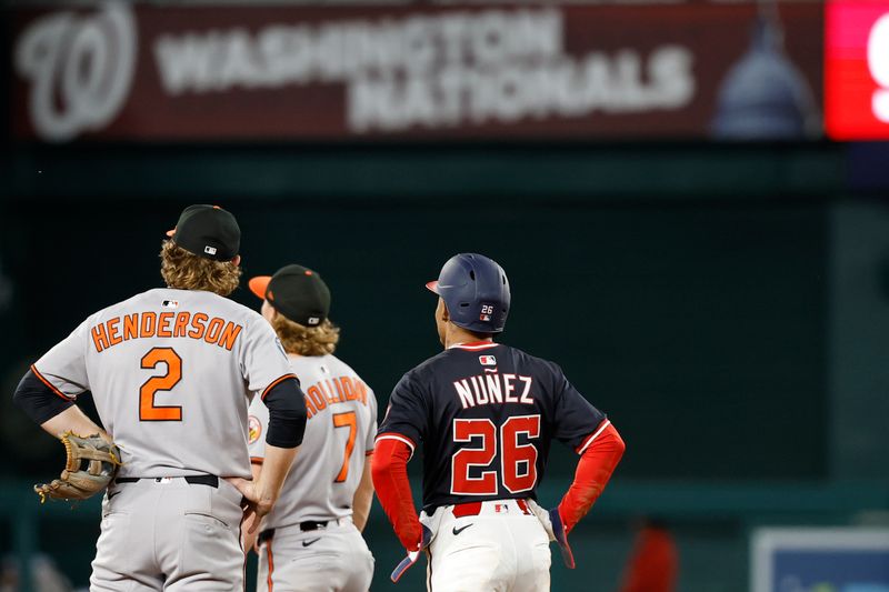 Apr 24, 2025; Washington, District of Columbia, USA; Baltimore Orioles shortstop Gunnar Henderson (2), Washington Nationals shortstop Nasim Nuñez (26), and Orioles second base Jackson Holliday (7) watch video challenge of Nunez' stolen base attempt during the ninth inning at Nationals Park. Mandatory Credit: Geoff Burke-Imagn Images