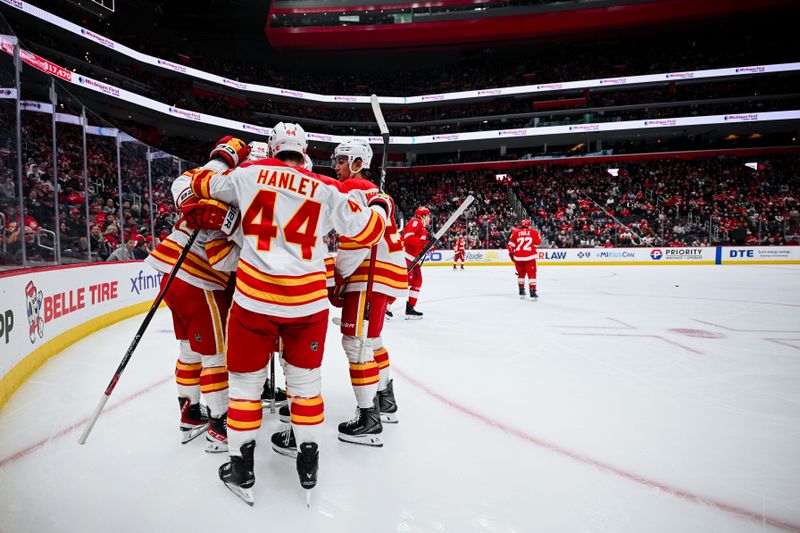 Mar 16, 2026; Detroit, Michigan, USA; Calgary Flames center Morgan Frost (16) celebrates his goal with teammates during the first period against the Detroit Red Wings at Little Caesars Arena. Mandatory Credit: Tim Fuller-Imagn Images