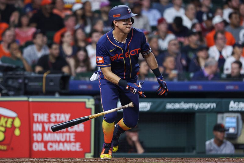 May 1, 2023; Houston, Texas, USA; Houston Astros second baseman Mauricio Dubon (14) hits an RBI single during the fifth inning against the San Francisco Giants at Minute Maid Park. Mandatory Credit: Troy Taormina-USA TODAY Sports