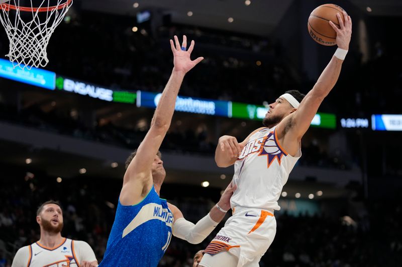 MILWAUKEE, WISCONSIN - MARCH 17: Devin Booker #1 of the Phoenix Suns shoots the ball against Brook Lopez #11 of the Milwaukee Bucks during the second half at Fiserv Forum on March 17, 2024 in Milwaukee, Wisconsin. NOTE TO USER: User expressly acknowledges and agrees that, by downloading and or using this photograph, User is consenting to the terms and conditions of the Getty Images License Agreement. (Photo by Patrick McDermott/Getty Images)