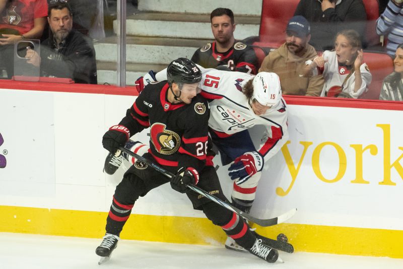 Oct 18, 2023; Ottawa, Ontario, CAN; Ottawa Senators defenseman Erik Brannstrom (26) battles with Washington Capitals left wing Sonny Milano (15) in the third period at the Canadian Tire Centre. Mandatory Credit: Marc DesRosiers-USA TODAY Sports