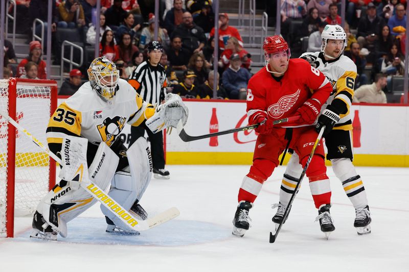 Oct 18, 2023; Detroit, Michigan, USA; Detroit Red Wings right wing Daniel Sprong (88) and Pittsburgh Penguins defenseman Erik Karlsson (65) fight for position in front of goaltender Tristan Jarry (35) in the second periodat Little Caesars Arena. Mandatory Credit: Rick Osentoski-USA TODAY Sports