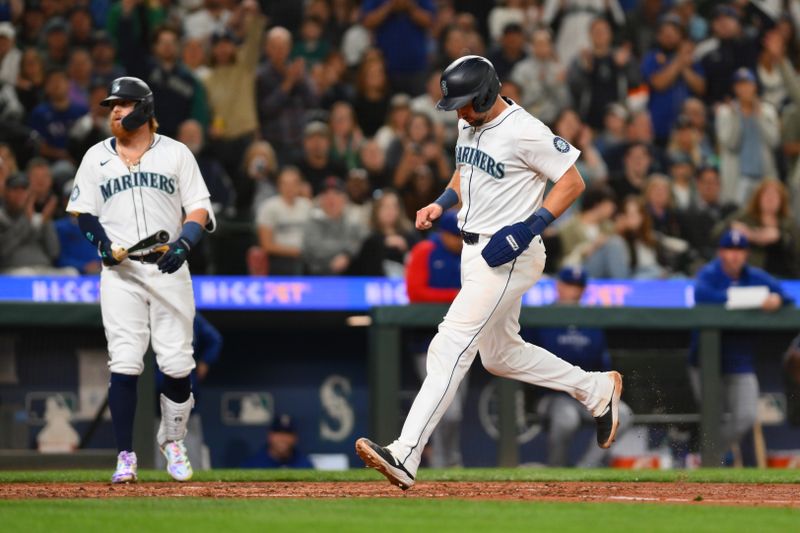 Sep 12, 2024; Seattle, Washington, USA; Seattle Mariners catcher Cal Raleigh (29) scores a run on a Texas Rangers wild pitch during the fifth inning at T-Mobile Park. Mandatory Credit: Steven Bisig-Imagn Images