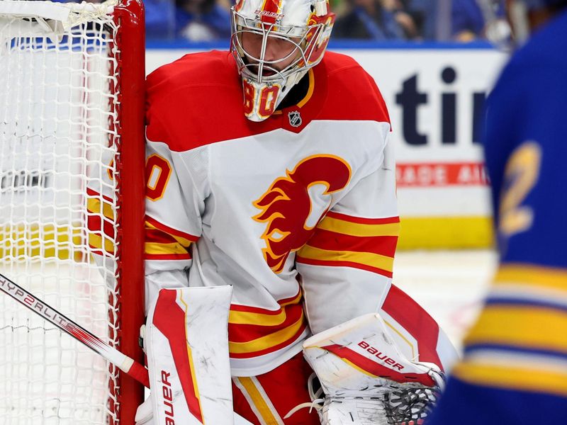 Nov 9, 2024; Buffalo, New York, USA;  Calgary Flames goaltender Dan Vladar (80) looks for the puck during the second period against the Buffalo Sabres at KeyBank Center. Mandatory Credit: Timothy T. Ludwig-Imagn Images