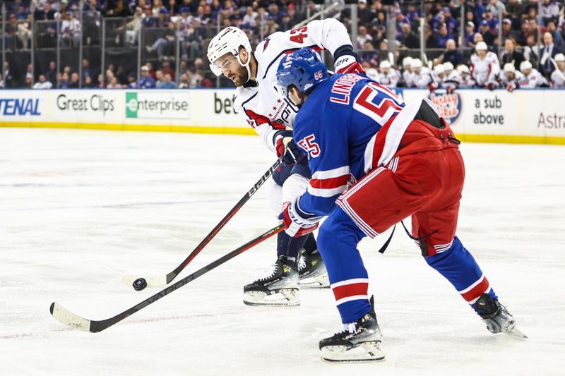 Apr 21, 2024; New York, New York, USA; Washington Capitals right wing Tom Wilson (43) and New York Rangers defenseman Ryan Lindgren (55) battle for control of the puck in the third period in game one of the first round of the 2024 Stanley Cup Playoffs at Madison Square Garden. Mandatory Credit: Wendell Cruz-USA TODAY Sports