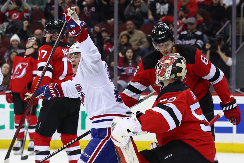 Jan 17, 2024; Newark, New Jersey, USA; Montreal Canadiens right wing Cole Caufield (22) celebrates his goal against the New Jersey Devils during the third period at Prudential Center. Mandatory Credit: Ed Mulholland-USA TODAY Sports