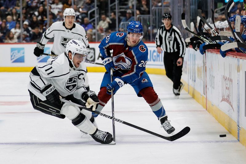 Jan 26, 2024; Denver, Colorado, USA; Los Angeles Kings center Anze Kopitar (11) and Colorado Avalanche center Ross Colton (20) battle for the puck in the third period at Ball Arena. Mandatory Credit: Isaiah J. Downing-USA TODAY Sports