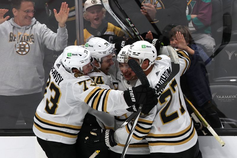 Oct 22, 2023; Anaheim, California, USA;  Boston Bruins center Matthew Poitras (51) celebrates with teammates after scoring his second goal of the game during the third period against the Anaheim Ducks at Honda Center. Mandatory Credit: Kiyoshi Mio-USA TODAY Sports