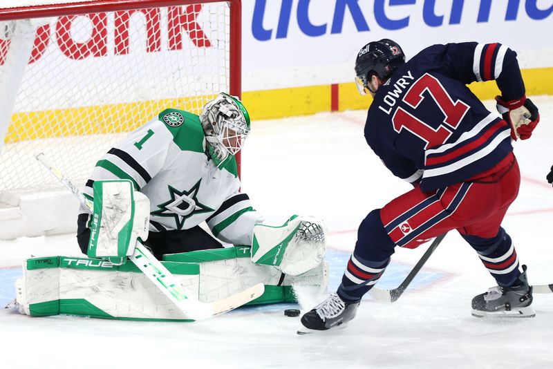 Dec 9, 2025; Winnipeg, Manitoba, CAN; Dallas Stars goaltender Casey Desmith (1) stops a shot by Winnipeg Jets center Adam Lowry (17) in the third period at Canada Life Centre. Mandatory Credit: James Carey Lauder-Imagn Images