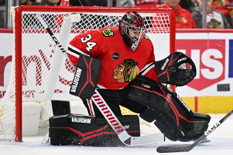 Dec 19, 2023; Chicago, Illinois, USA; Chicago Blackhawks goaltender Petr Mrazek (34) makes a save in the second period against the Colorado Avalanche at United Center. Mandatory Credit: Jamie Sabau-USA TODAY Sports