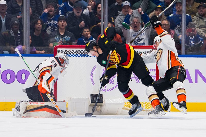 Nov 28, 2023; Vancouver, British Columbia, CAN; After winning a puck battle against Anaheim Ducks defenseman Pavel Mintyukov (34) Vancouver Canucks forward Brock Boeser (6) scores on goalie John Gibson (36) in the first period at Rogers Arena. Mandatory Credit: Bob Frid-USA TODAY Sports