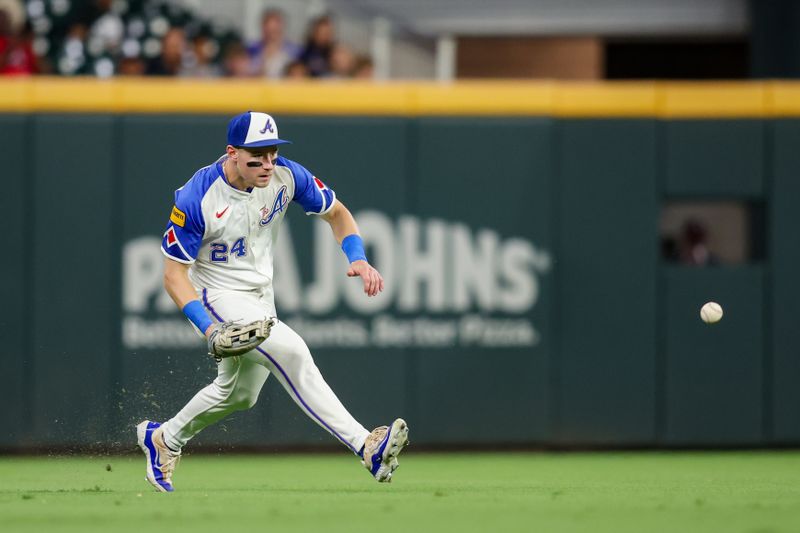 Sep 7, 2024; Atlanta, Georgia, USA; Atlanta Braves left fielder Jarred Kelenic (24) fields a ball against the Toronto Blue Jays in the fifth inning at Truist Park. Mandatory Credit: Brett Davis-Imagn Images
