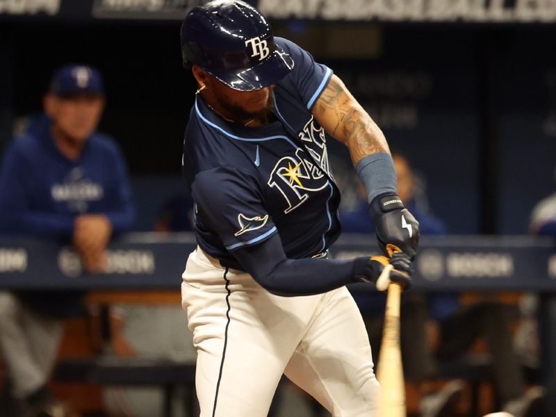 Apr 2, 2024; St. Petersburg, Florida, USA; Tampa Bay Rays outfielder Harold Ramirez (43) singles against the Texas Rangers during the third inning at Tropicana Field. Mandatory Credit: Kim Klement Neitzel-USA TODAY Sports