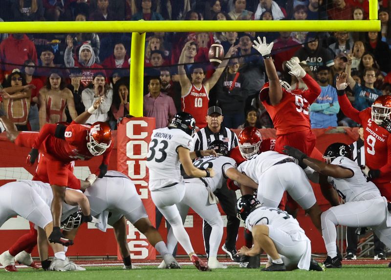 Nov 11, 2023; Houston, Texas, USA; Cincinnati Bearcats place kicker Carter Brown (33) makes an extra point against the Houston Cougars in the first half at TDECU Stadium. Mandatory Credit: Thomas Shea-USA TODAY Sports