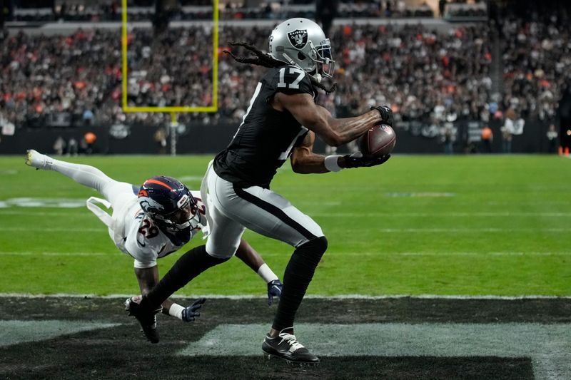 Las Vegas Raiders wide receiver Davante Adams (17) catches a touchdown pass against the Denver Broncos during an NFL football game, Sunday, Jan. 7, 2024, in Las Vegas. (AP Photo/John Locher)