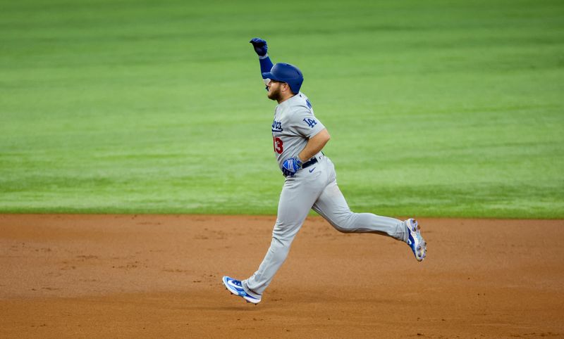 Jul 23, 2023; Arlington, Texas, USA;  Los Angeles Dodgers third baseman Max Muncy (13) celebrates after hitting a grand slam during the first inning against the Texas Rangers at Globe Life Field. Mandatory Credit: Kevin Jairaj-USA TODAY Sports