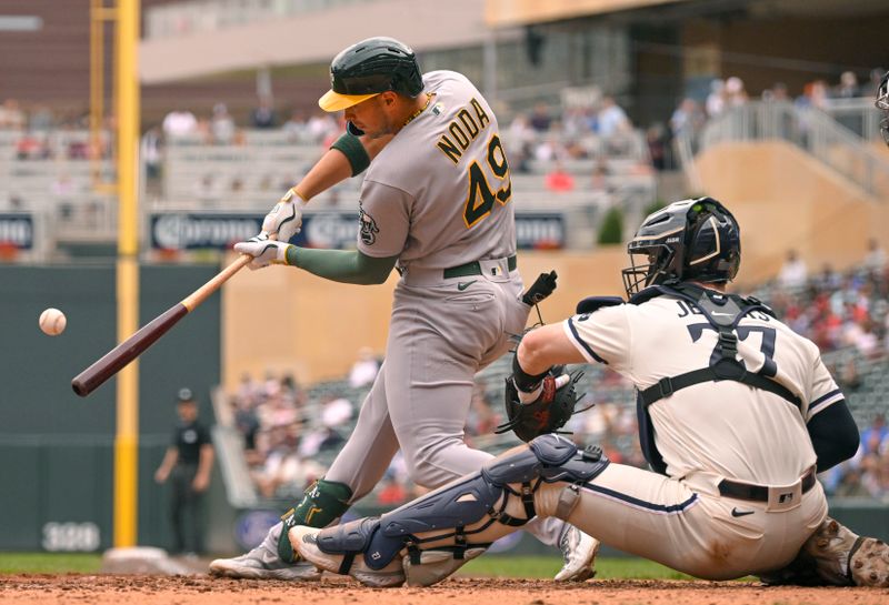 Sep 28, 2023; Minneapolis, Minnesota, USA; Oakland Athletics infielder Ryan Noda (49) hits a solo home run against the Minnesota Twins during the eighth inning at Target Field. Mandatory Credit: Nick Wosika-USA TODAY Sports