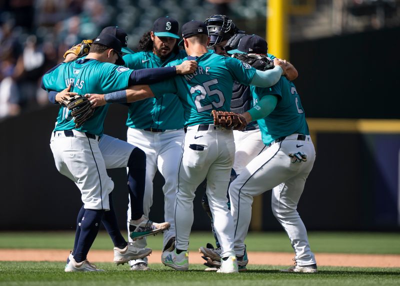 May 15, 2024; Seattle, Washington, USA; Seattle Mariners infielders including third baseman Luis Urias (16), left, relief pitcher Andres Munoz (75), third from left, shortstop Dylan Moore (25) and first baseman Ty France (23), right, celebrate after a game against the Kansas City Royals  at T-Mobile Park. Mandatory Credit: Stephen Brashear-USA TODAY Sports