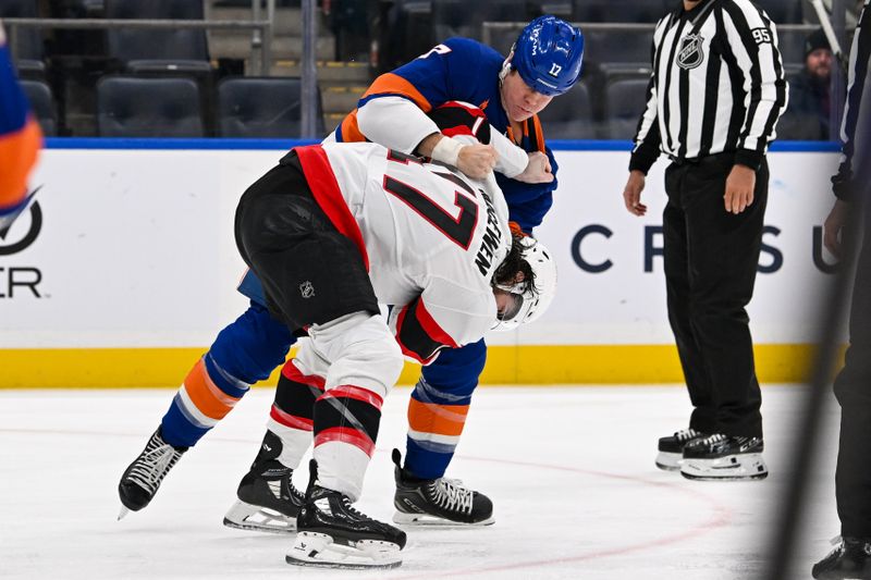 Jan 14, 2025; Elmont, New York, USA;  New York Islanders left wing Matt Martin (17) and Ottawa Senators right wing Zack MacEwen (17) fight during the first period at UBS Arena. Mandatory Credit: Dennis Schneidler-Imagn Images