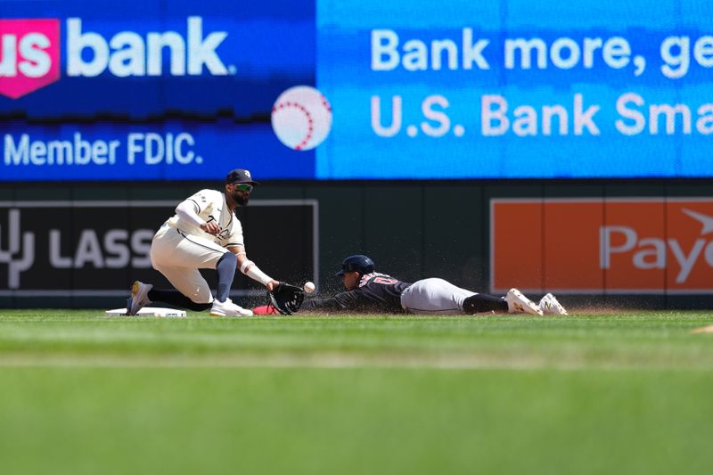 Aug 11, 2024; Minneapolis, Minnesota, USA; Cleveland Guardians second baseman Andres Gimenez (0) beats the tag at second base from Minnesota Twins shortstop Willi Castro (50) during the fourth inning at Target Field. Mandatory Credit: Jordan Johnson-USA TODAY Sports
