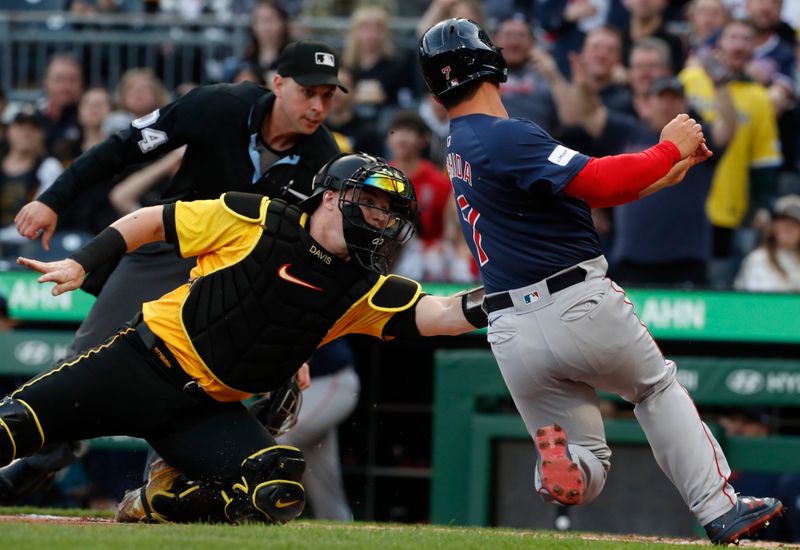 Apr 19, 2024; Pittsburgh, Pennsylvania, USA;  Pittsburgh Pirates catcher Henry Davis (32) tags Boston Red Sox designated hitter Masataka Yoshida (7) out at home plate attempting to score a run during the second inning at PNC Park. Mandatory Credit: Charles LeClaire-USA TODAY Sports