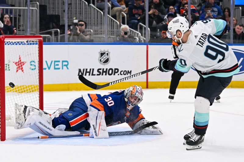 Feb 13, 2024; Elmont, New York, USA; Seattle Kraken left wing Tomas Tatar (90) scores a goal past New York Islanders goaltender Ilya Sorokin (30) during shoot outs  at UBS Arena. Mandatory Credit: Dennis Schneidler-USA TODAY Sports