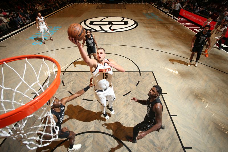 BROOKLYN, NY - OCTOBER 29: Nikola Jokic #15 of the Denver Nuggets drives to the basket during the game against the Brooklyn Nets on October 29, 2024 at Barclays Center in Brooklyn, New York. NOTE TO USER: User expressly acknowledges and agrees that, by downloading and or using this Photograph, user is consenting to the terms and conditions of the Getty Images License Agreement. Mandatory Copyright Notice: Copyright 2024 NBAE (Photo by Nathaniel S. Butler/NBAE via Getty Images)