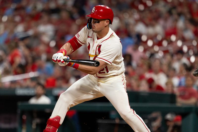 Sep 30, 2023; St. Louis, Missouri, USA; St. Louis Cardinals center fielder Lars Nootbaar (21) bunts in the eighth inning against the Cincinnati Reds at Busch Stadium. Mandatory Credit: Zach Dalin-USA TODAY Sports