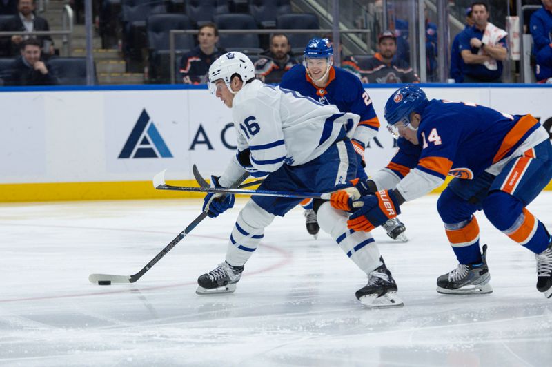 Dec 11, 2023; Elmont, New York, USA; Toronto Maple Leafs right wing Mitchell Marner (16) skates with the puck against the New York Islanders during the first period at UBS Arena. Mandatory Credit: Thomas Salus-USA TODAY Sports