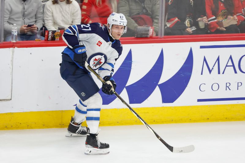 Feb 23, 2024; Chicago, Illinois, USA; Winnipeg Jets left wing Nikolaj Ehlers (27) looks to pass the puck against the Chicago Blackhawks during the first period at United Center. Mandatory Credit: Kamil Krzaczynski-USA TODAY Sports