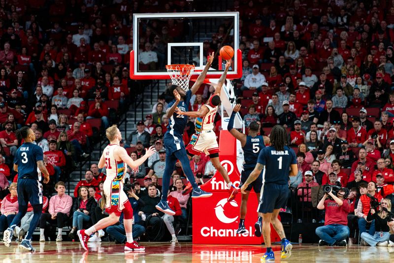 Feb 17, 2024; Lincoln, Nebraska, USA; Penn State Nittany Lions forward Qudus Wahab (22) blocks a shot by Nebraska Cornhuskers guard Jamarques Lawrence (10) during the second half at Pinnacle Bank Arena. Mandatory Credit: Dylan Widger-USA TODAY Sports