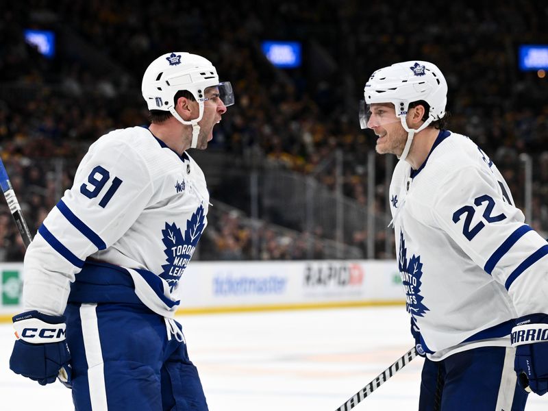 Apr 22, 2024; Boston, Massachusetts, USA; Toronto Maple Leafs center John Tavares (91) reacts with defenseman Jake McCabe (22) after scoring a goal against the Boston Bruins during the second period in game two of the first round of the 2024 Stanley Cup Playoffs at TD Garden. Mandatory Credit: Brian Fluharty-USA TODAY Sports