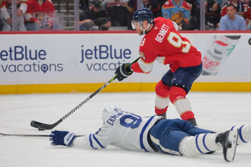 May 9, 2025; Sunrise, Florida, USA; Florida Panthers center Sam Bennett (9) moves the puck past Toronto Maple Leafs defenseman Oliver Ekman-Larsson (95) during the second period in game three of the second round of the 2025 Stanley Cup Playoffs at Amerant Bank Arena. Mandatory Credit: Sam Navarro-Imagn Images