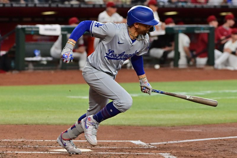 May 1, 2024; Phoenix, Arizona, USA;  Los Angeles Dodgers shortstop Mookie Betts (50) hits a two-RBI single in the second inning against the Arizona Diamondbacks at Chase Field. Mandatory Credit: Matt Kartozian-USA TODAY Sports