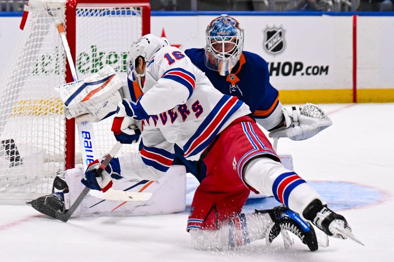 Apr 10, 2025; Elmont, New York, USA;  New York Islanders goaltender Marcus Hogberg (50) makes a save on New York Rangers center Vincent Trocheck (16) during the third period at UBS Arena. Mandatory Credit: Dennis Schneidler-Imagn Images