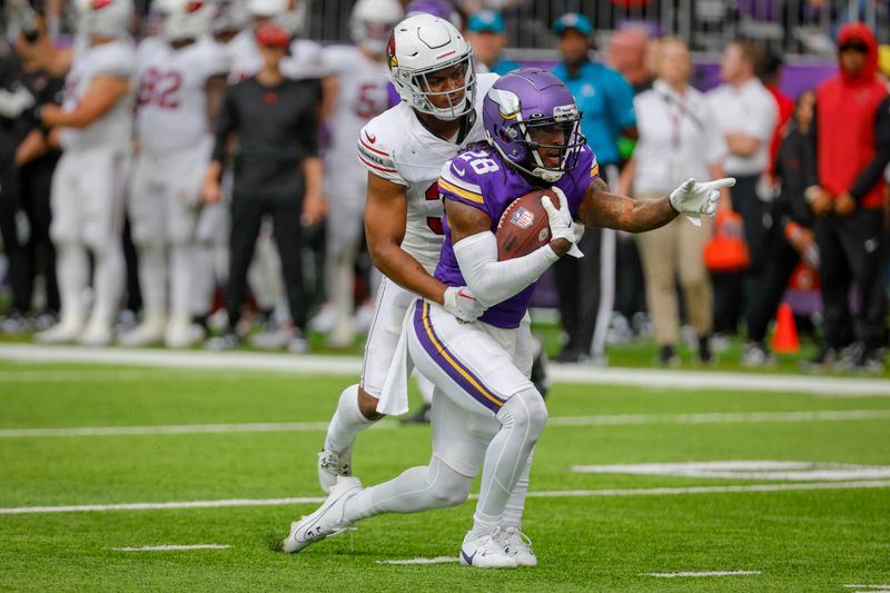 Minnesota Vikings wide receiver Jacob Copeland (28) celebrates his first down catch against Arizona Cardinals safety JuJu Hughes (36) during the second half of an NFL preseason football game, Saturday, Aug. 26, 2023, in Minneapolis. (AP Photo/Bruce Kluckhohn)