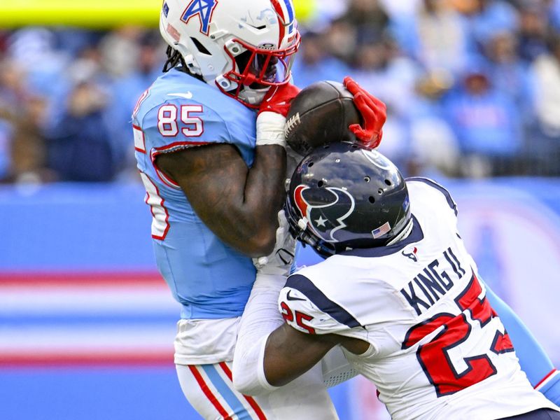 Tennessee Titans tight end Chigoziem Okonkwo (85) makes a catch as Houston Texans cornerback Desmond King II (25) defends in an NFL football game Sunday, Dec. 17, 2023, in Nashville, Tenn. (AP Photo/John Amis)