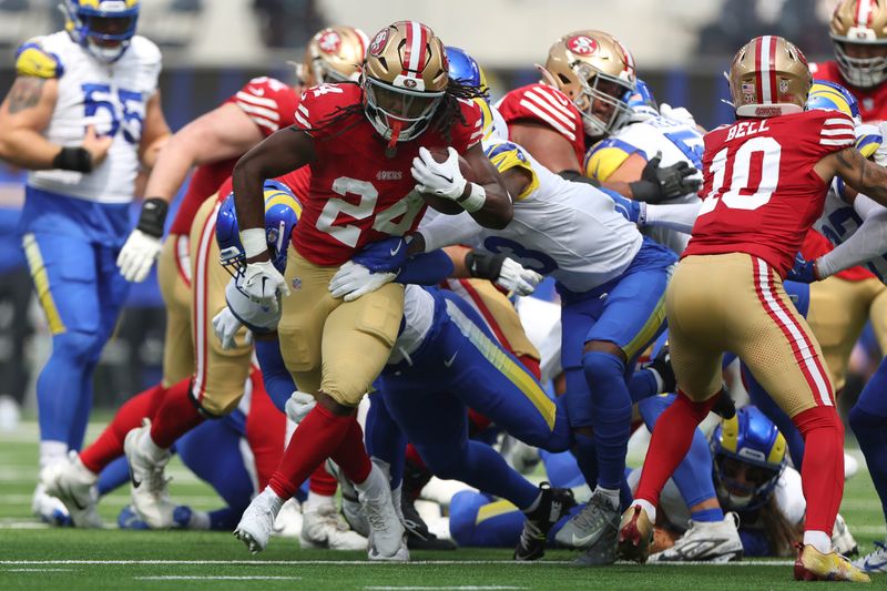 San Francisco 49ers running back Jordan Mason (24) runs against the Los Angeles Rams during the first half of an NFL football game, Sunday, Sept. 22, 2024, in Inglewood, Calif. (AP Photo/Ryan Sun)