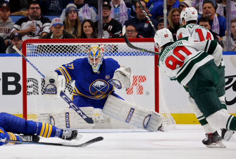 Nov 10, 2023; Buffalo, New York, USA;  Buffalo Sabres goaltender Devon Levi (27) makes a blocker save on Minnesota Wild left wing Marcus Johansson (90) during the second period at KeyBank Center. Mandatory Credit: Timothy T. Ludwig-USA TODAY Sports