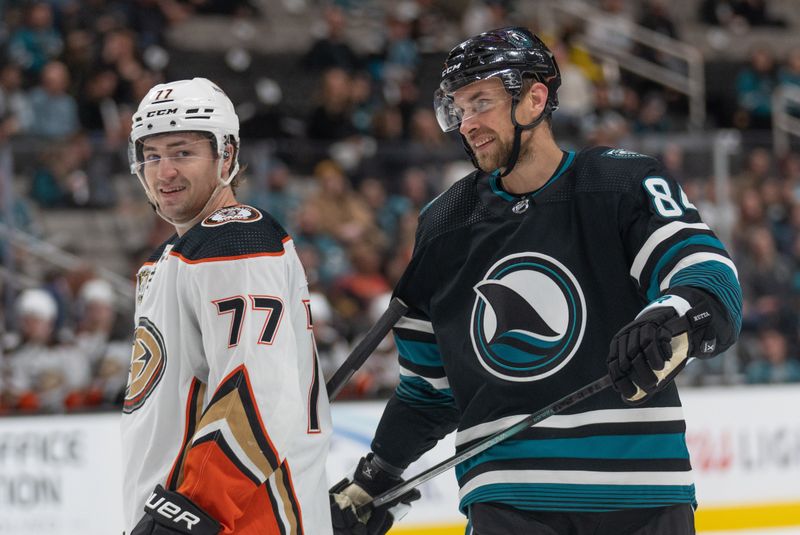 Feb 29, 2024; San Jose, California, USA; Anaheim Ducks right wing Frank Vatrano (77) smiles alongside San Jose Sharks defenseman Jan Rutta (84) during the third period at SAP Center at San Jose. Mandatory Credit: Stan Szeto-USA TODAY Sports