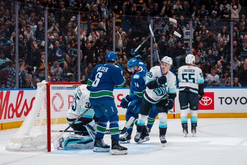 Jan 2, 2026; Vancouver, British Columbia, CAN; Seattle Kraken forward Ryan Winterton (26) reacts as Vancouver Canucks forward Brock Boeser (6) and forward Jake DeBrusk (74) celebrate DeBrusk’s goal scored on goalie Joey Daccord (35) in the second period at Rogers Arena. Mandatory Credit: Bob Frid-Imagn Images