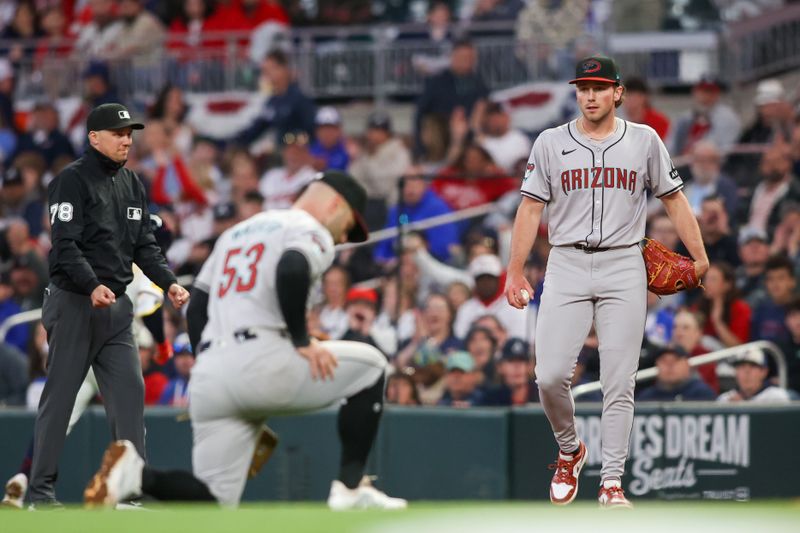 Apr 6, 2024; Atlanta, Georgia, USA; Arizona Diamondbacks starting pitcher Brandon Pfaadt (32) looks at first baseman Christian Walker (53) after an error against the Atlanta Braves in the third inning at Truist Park. Mandatory Credit: Brett Davis-USA TODAY Sports