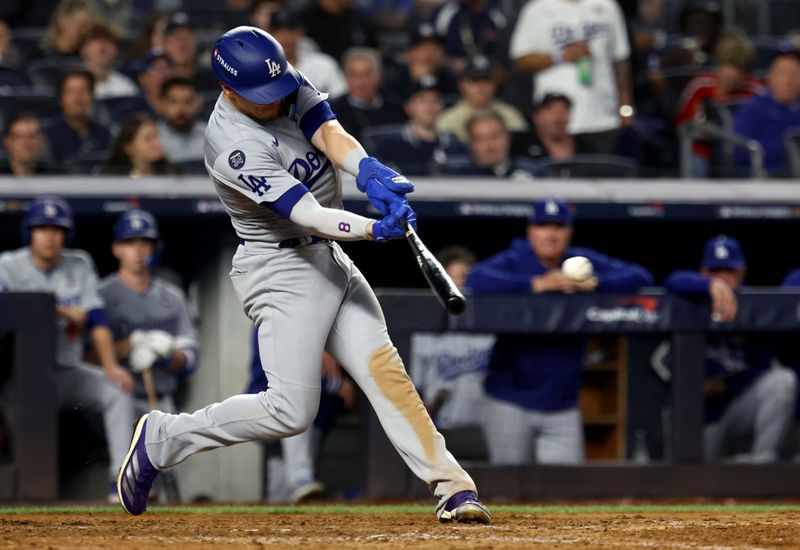 Oct 30, 2024; New York, New York, USA; Los Angeles Dodgers third baseman Enrique Hernandez (8) singles during the eighth inning against the New York Yankees in game five of the 2024 MLB World Series at Yankee Stadium. Mandatory Credit: Vincent Carchietta-Imagn Images