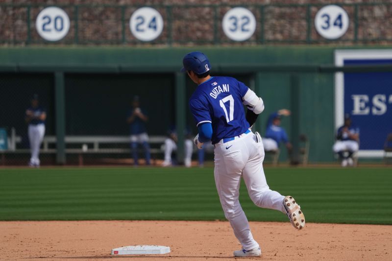 Feb 27, 2024; Phoenix, Arizona, USA; Los Angeles Dodgers designated hitter Shohei Ohtani (17) runs the bases after hitting a two run home run during the fifth inning against the Chicago White Sox at Camelback Ranch-Glendale. Mandatory Credit: Joe Camporeale-USA TODAY Sports