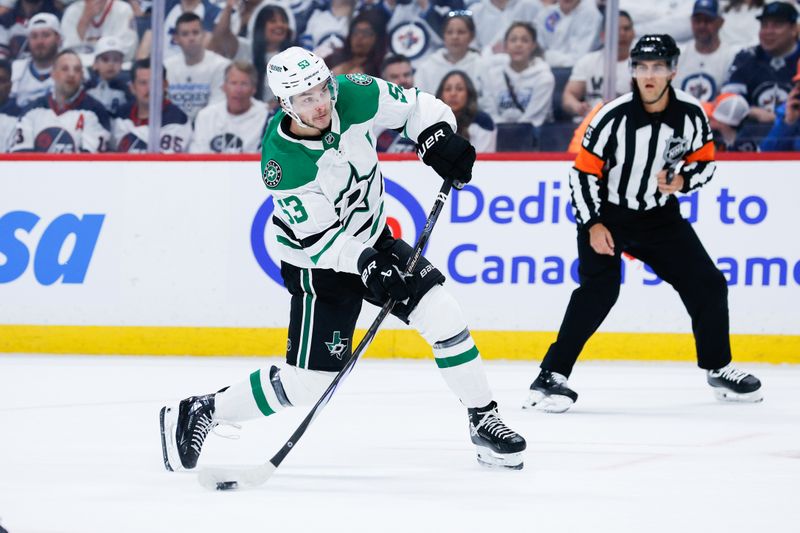 May 7, 2025; Winnipeg, Manitoba, CAN; Dallas Stars forward Wyatt Johnston (53) takes a shot against the Winnipeg Jets during the first period in game one of the second round of the 2025 Stanley Cup Playoffs at Canada Life Centre. Mandatory Credit: Terrence Lee-Imagn Images