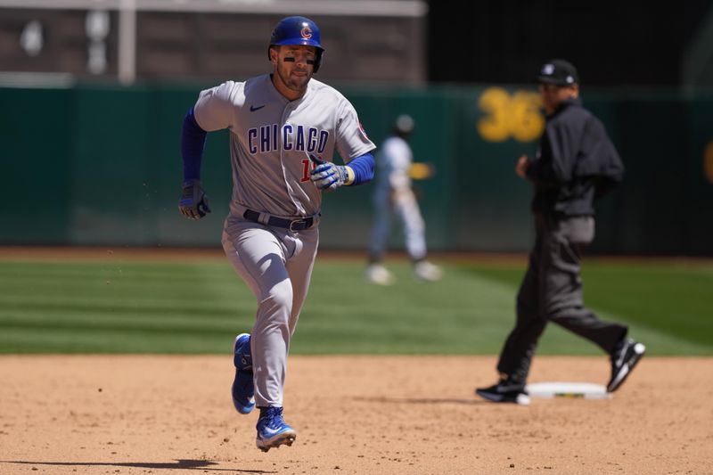 Apr 19, 2023; Oakland, California, USA; Chicago Cubs right fielder Patrick Wisdom (16) runs to third base for a triple during the sixth inning against the Oakland Athletics at Oakland-Alameda County Coliseum. Mandatory Credit: Darren Yamashita-USA TODAY Sports